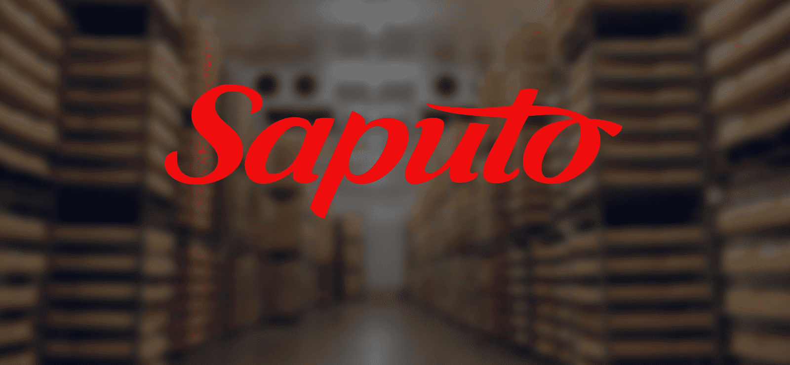 Logo of Saputo, a leading dairy company, displayed in a warehouse filled with stacked cheese products, symbolizing quality and production in the dairy industry.